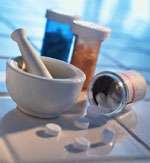 Photo of pestle and mortar and bottle of pills